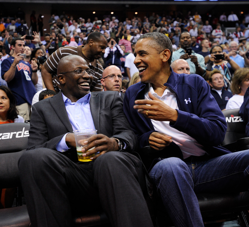 President Barack Obama shares a laugh with former White House aide Reggie Love as they watch the U.S. Senior Men’s National Team and Brazil play during a pre-Olympic exhibition basketball game at the Verizon Center on July 16, 2012, in Washington, D.C. Leslie E. Kossoff-Pool/Getty Images